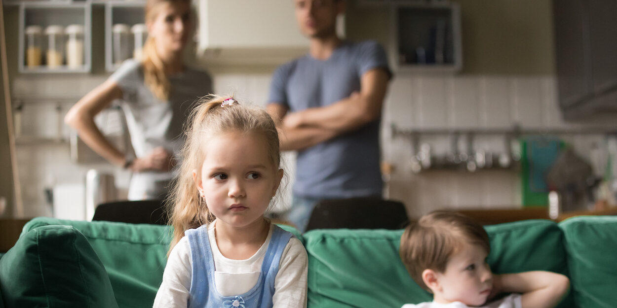 Kid girl upset, offended or bored ignoring parents and brother